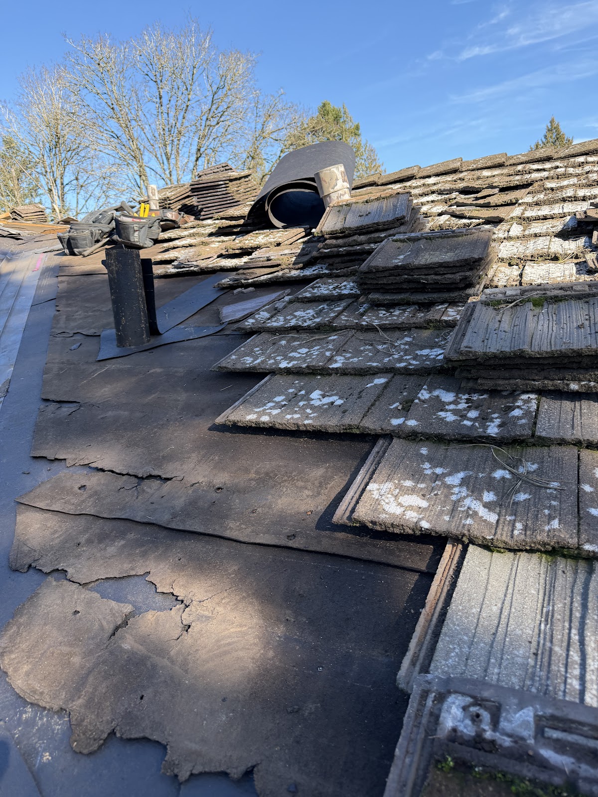 Tilly's crew stripping back an old tile roof to the decking in Oregon City